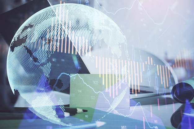 Financial chart drawing and table with computer on background Multi exposure Concept of international markets