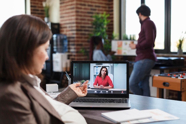 Financial company pregnant employee in teleconference videocall\
with agency colleague discussing about business plan. business\
woman conferencing with project manager about necessity of hiring\
people.