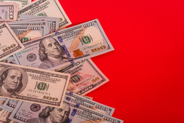 Financial concept. Dollars banknotes on red background, money.