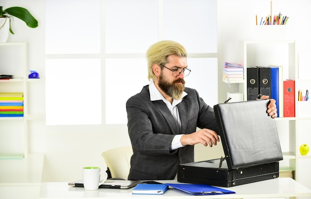 Financial concept. suitcase with money. good deal. modern life and business. corporate leather bag. mature man with case at workstation. male office fashion. Businessman hand holding briefcase.