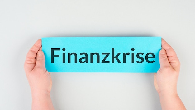 Financial crisis is standing in german language on the paper, economic recession, inflation