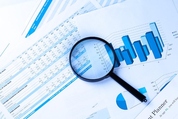 Photo financial documents with magnifying glass over them