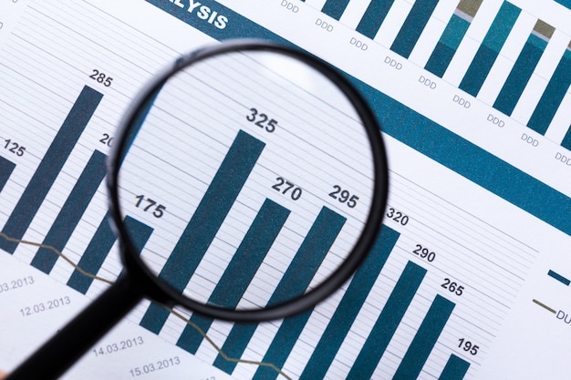 Financial documents with magnifying glass