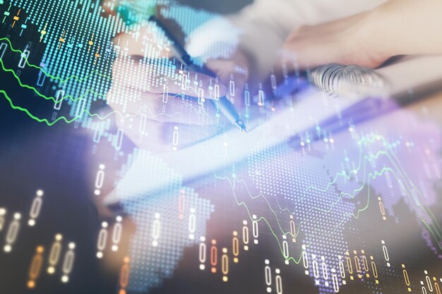 Financial forex graph displayed on hands taking notes background Concept of research Double exposure