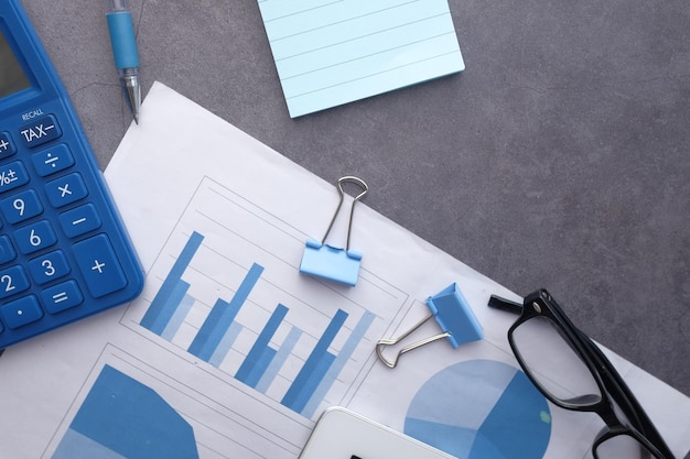 Financial graph calculator and notepad on table using self created chart