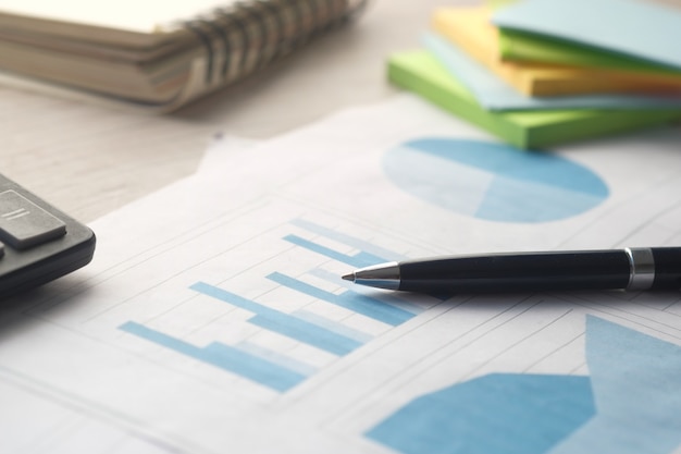 Financial graph calculator and notepad on table