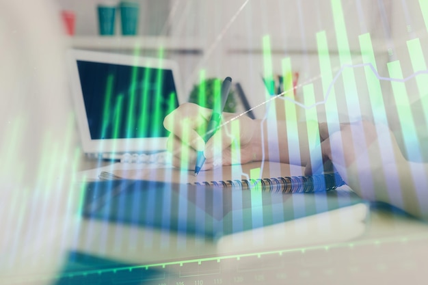 Financial graph displayed on woman's hand taking notes background concept of research double exposure