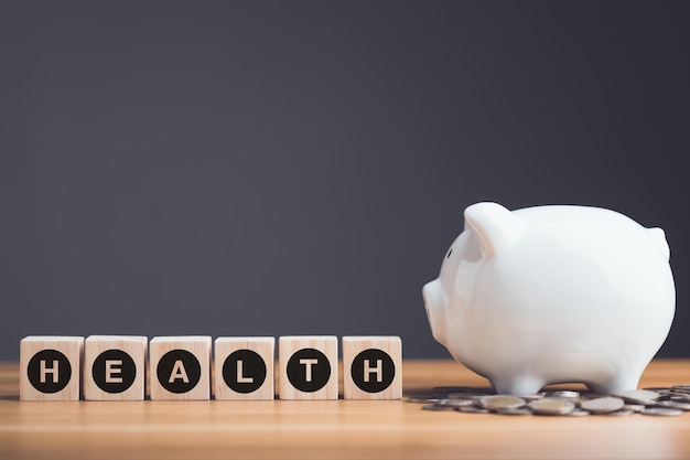 Financial for health concept The idea of saving money for healthcare White piggy bank and coin on desk with grey copy space Health and finance concept