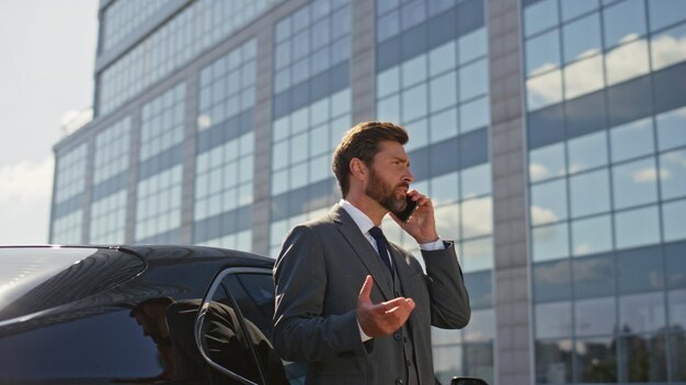 Financial manager talking cell phone on business district sunny morning close up