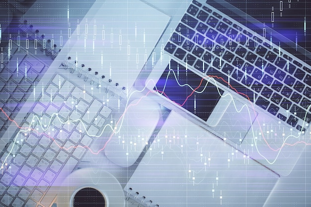 График финансового рынка и компьютер с видом сверху на фоне рабочего стола Мультиэкспозиция Инвестиционная концепция