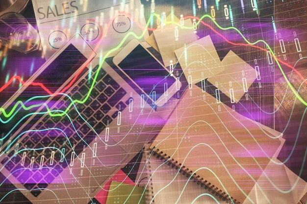 Financial market graph and top view computer on the desktop background Multi exposure Investment concept