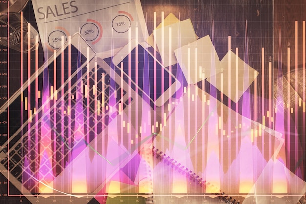 financial market graph and top view computer on the desktop background multi exposure investment concept