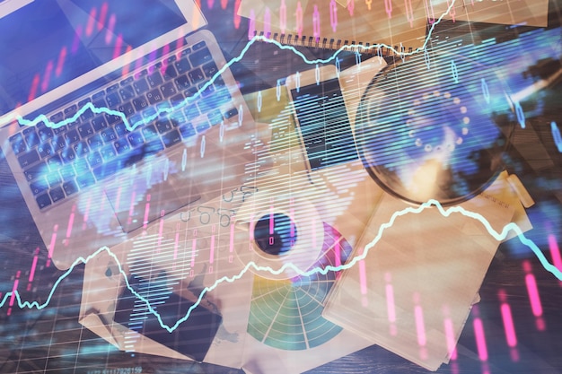 Financial market graph and top view computer on the desktop background Multi exposure Investment concept