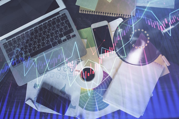 Financial market graph and top view computer on the desktop background Multi exposure Investment concept