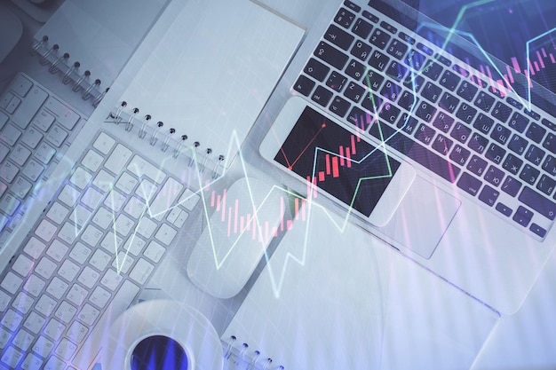 Financial market graph and top view computer on the desktop background Multi exposure Investment concept