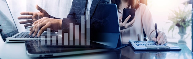 Financial report data of business operations balance sheet and income statement and diagram as Fintech conceptBusiness team meeting digital tablet and computer laptop