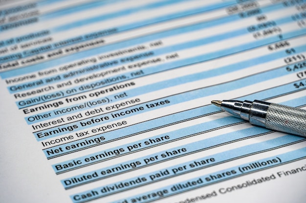 financial statement and eyeglass, business concept