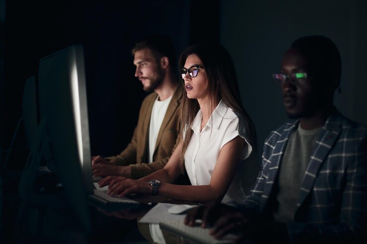 Photo financial team sitting in an office in front of a computer at nightpeople and technology