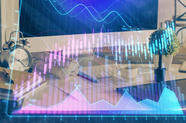 Foto financiële grafiek kleurrijke tekening en tabel met computer op de achtergrond dubbele blootstelling concept van internationale markten