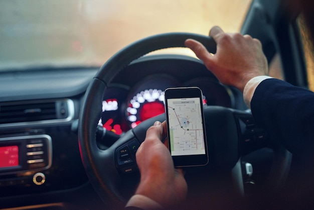 Finding his way on the road Shot of a businessman using his a gps map while driving