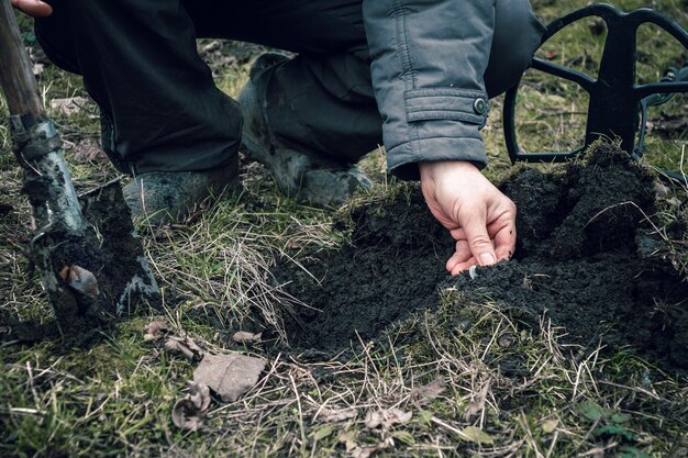 Finding old coins with a metal detector The man dug up an antique coin Fortuna during the instrumental search for antiquities