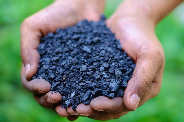 fine coal in worker's hands for energy concept