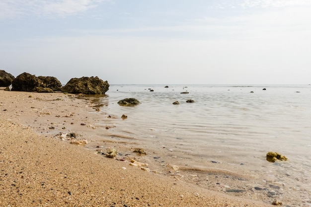 fine sand and coral rocks at the beach during ebb on vacation