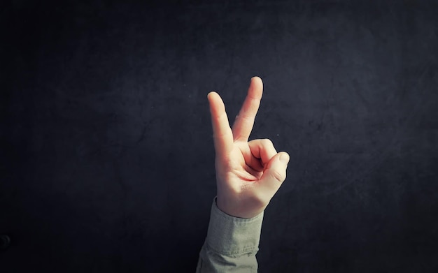 Finger gestures Male hands on a gray background Gesticulation with hands