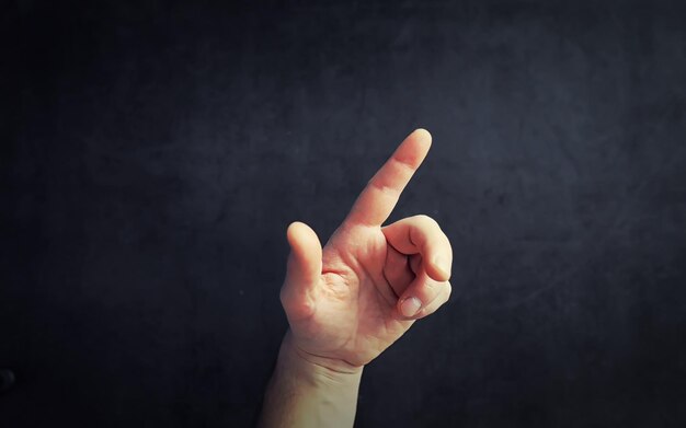 Finger gestures Male hands on a gray background Gesticulation with hands