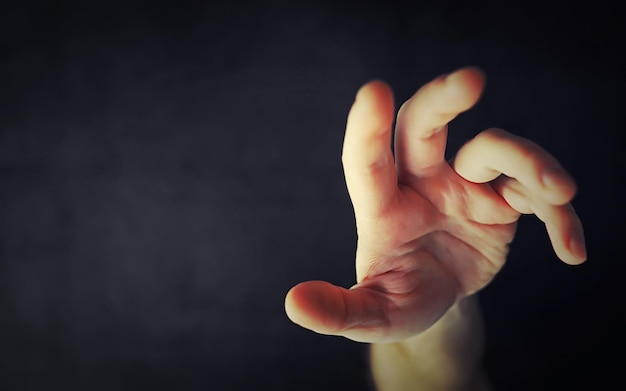 Finger gestures male hands on a gray background gesticulation
with hands