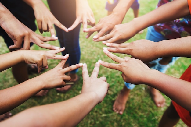 Finger of group circle of children at playground. concept teamwork