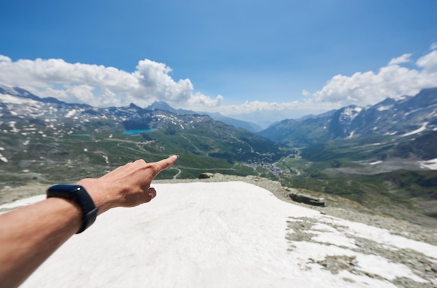 Finger pointing at mountains