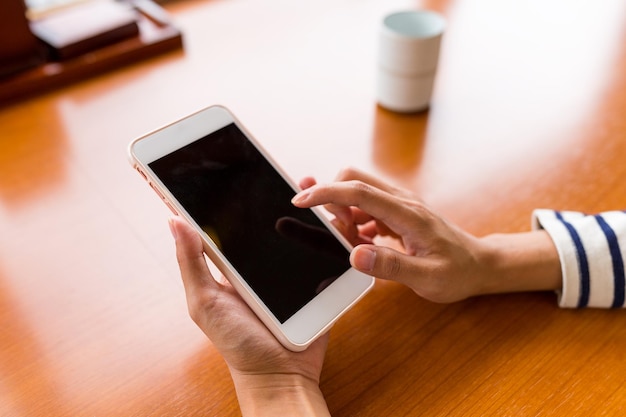 Finger using cellphone in restaurant