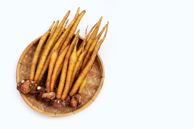 Fingerroot in bamboo basket on white background.