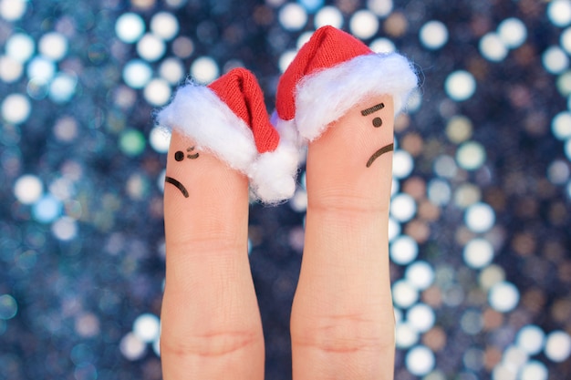 Fingers art of couple celebrates christmas. concept of man and woman during quarrel in new year