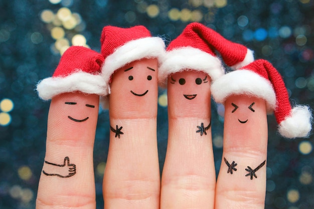 Fingers art of friends celebrates Christmas The concept of a group of people laughing in new year hats