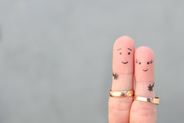 Fingers art of happy couple Concept of a husband and wife wearing wedding rings