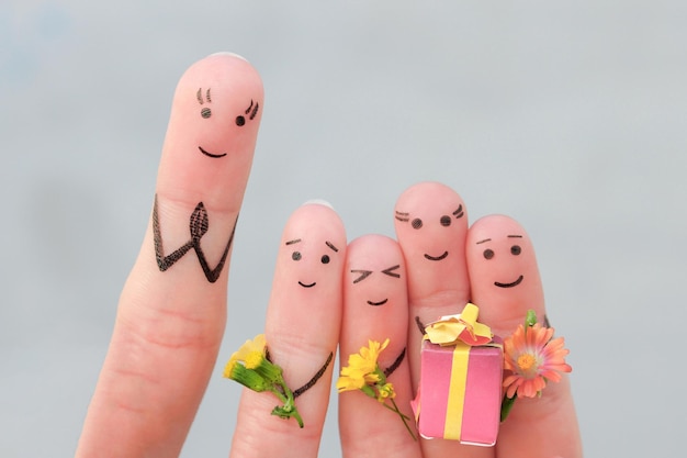 Fingers art of happy people Concept schoolchildren give flowers to the teacher Mother's Day Knowledge Day September 1 Teacher's Day