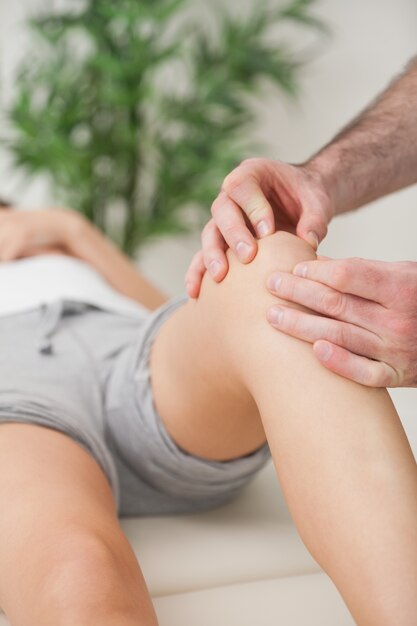 Fingers of a doctor massaging a leg