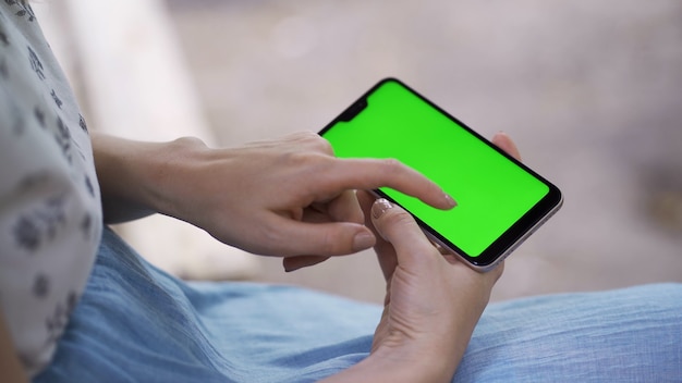 Fingers of girl touch screen of tablet smartphone closeup