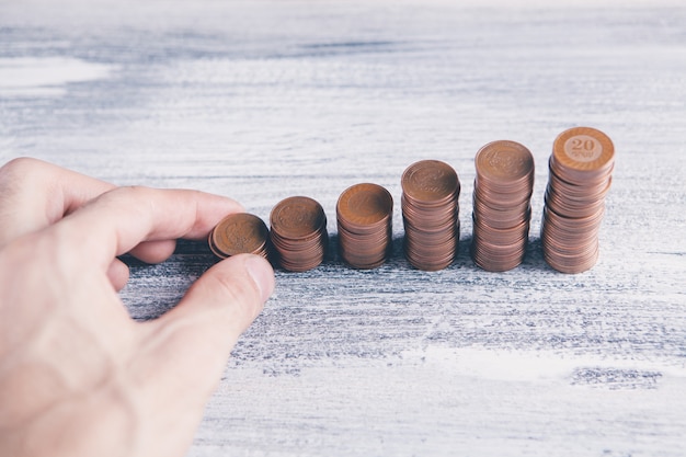 Fingers on stacks of coins