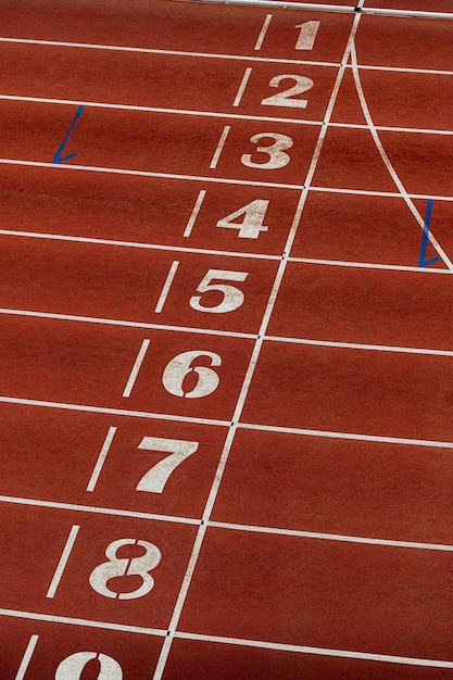 Finish line on red track of athletics stadium