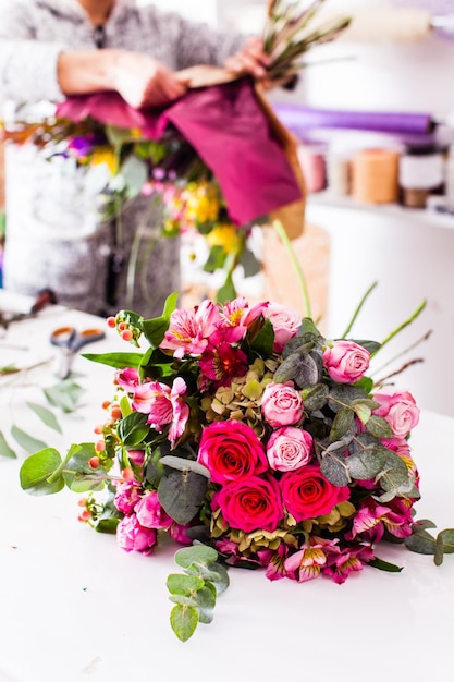 Finished bouquets on the table in the flower shop. Creating the floristic decorations