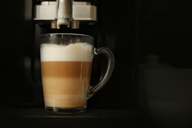 The finished coffee has three layers of white, beige and brown. Layering. Coffee with milk. High quality photo