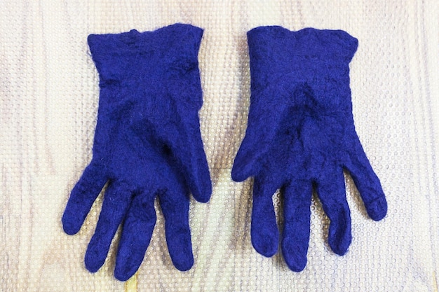 Finished wet felted gloves on mat