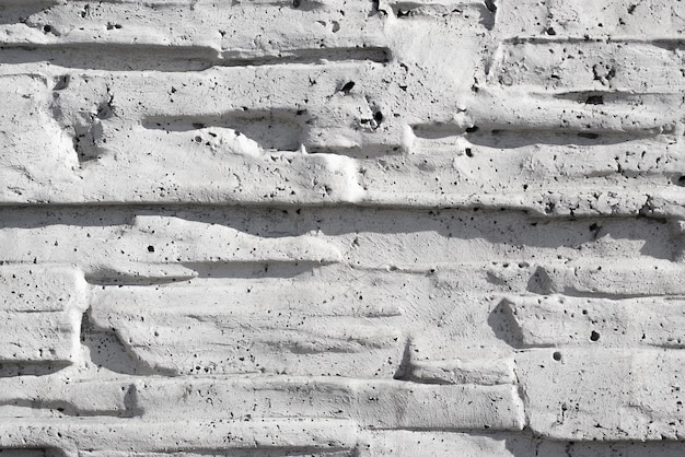 Finishing decorative gray rough brick and concrete wall Texture background