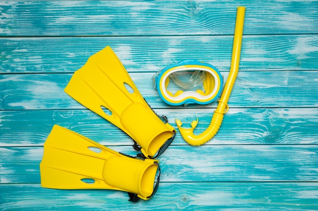 Fins, goggles and snorkel lying on the board