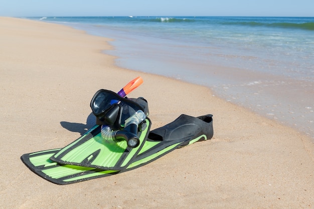 Fins, snorkel, mask for diving. On the beach the sea.