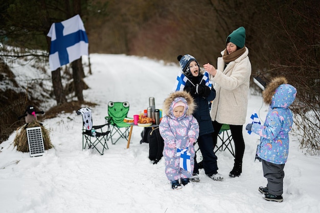 Finse vrouw en kinderen met Finse vlaggen op een mooie winterdag Noordse Scandinavische mensen