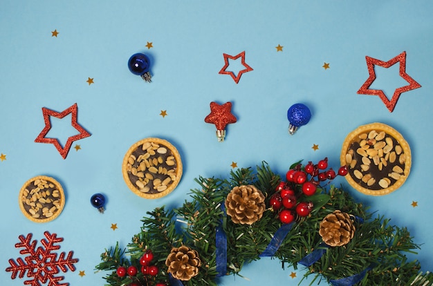 Fir branch with Christmas decoration on blue background